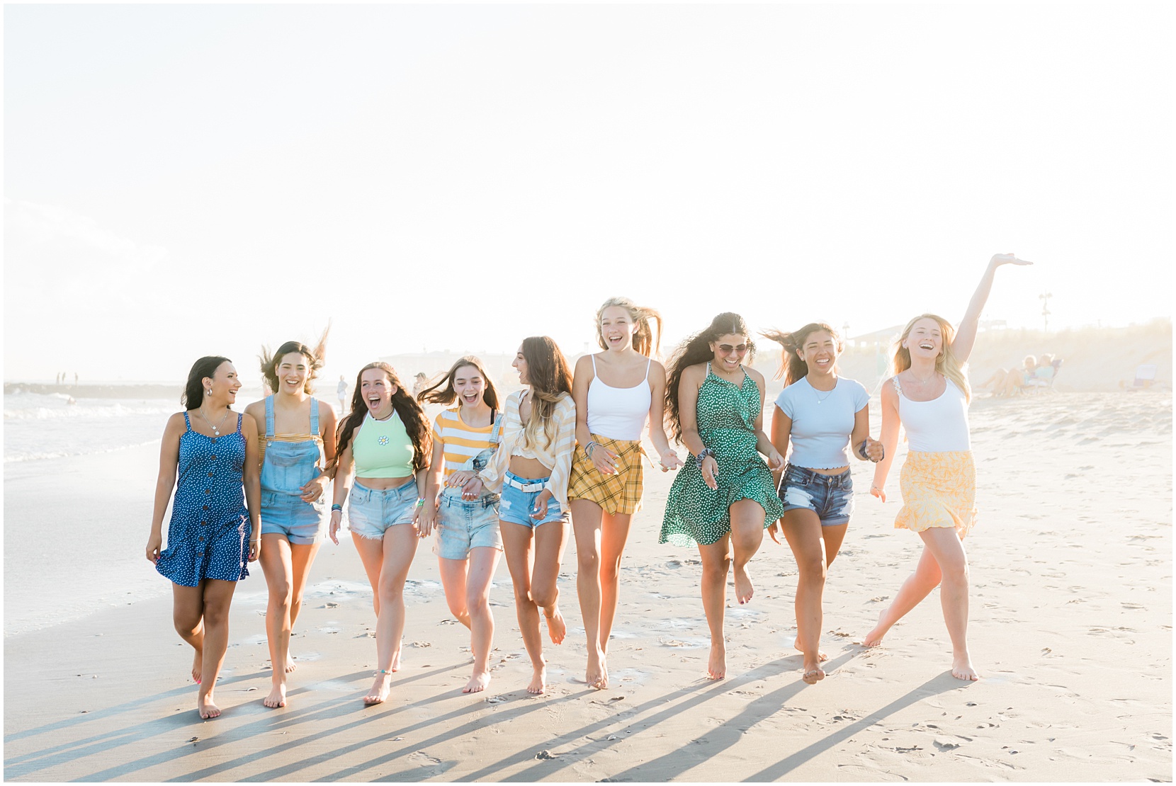 Nicole Marie Photography's senior model team skipping on the beach in Ocean City, New Jersey.