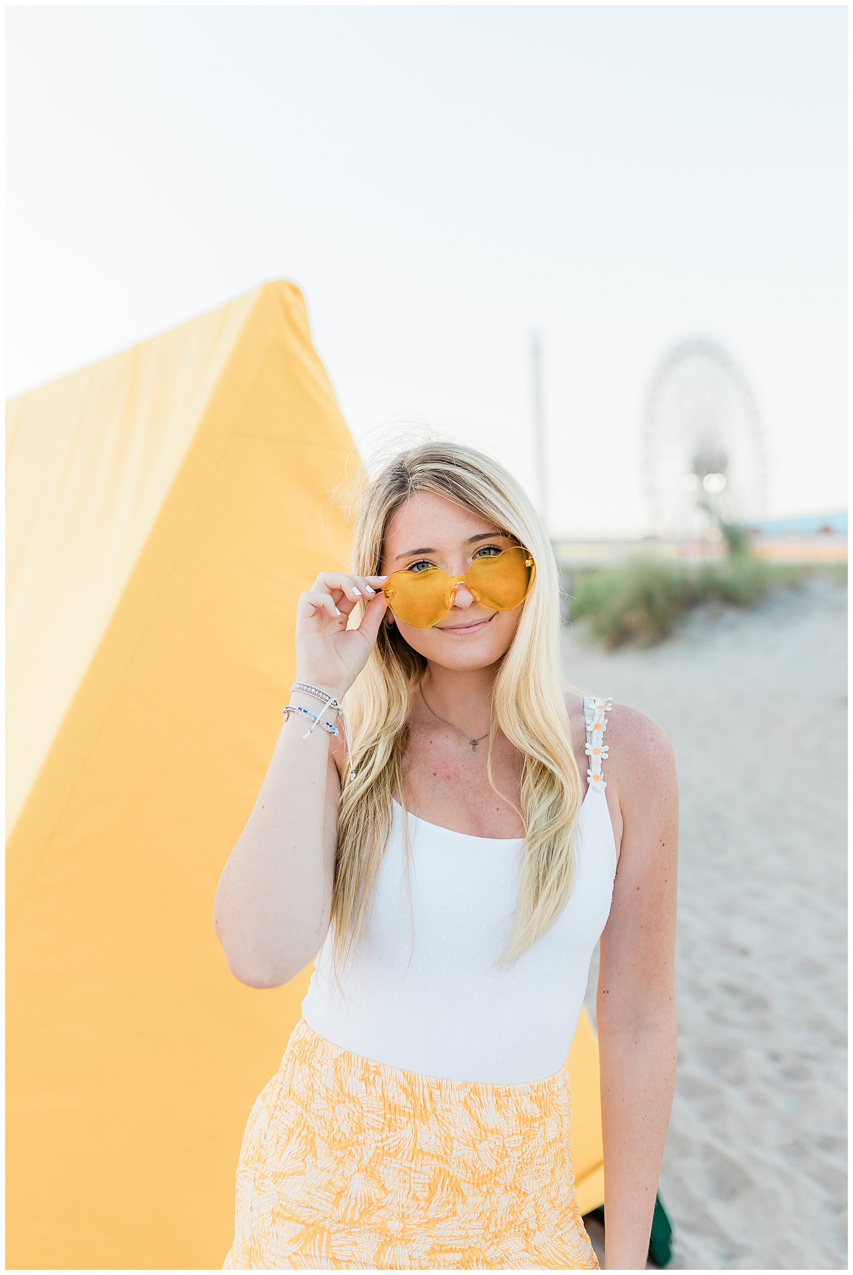 beach portraits, senior photos, ocean city, senior beach photos, senior model team, teen girl wearing yellow on the beach holding her sunglasses
