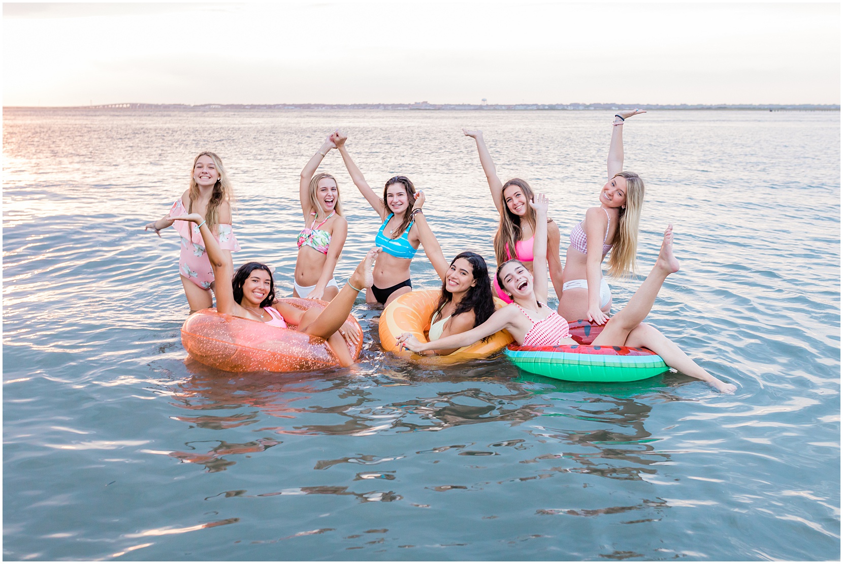 Nicole Marie Photography's senior model team on the bay with fruit floats