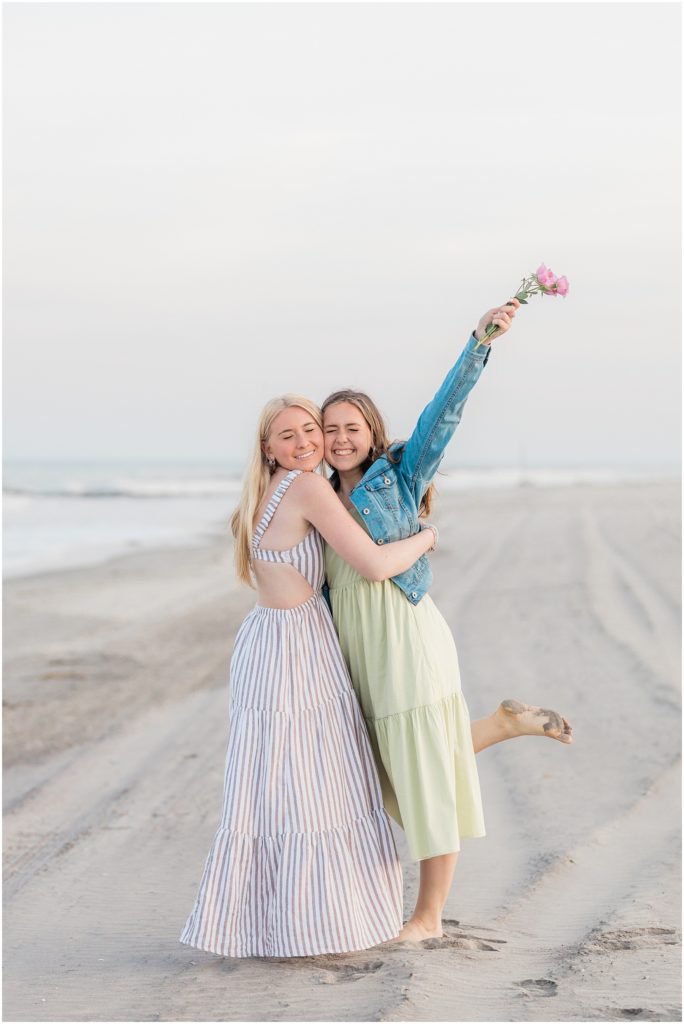 teen girls on the beach with flowers in ocean city new jersey